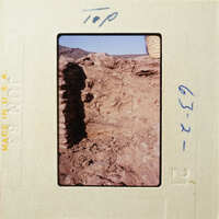 A photograph of an ancient rock structure with visible erosion and weathering.