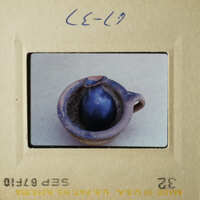 This is an image of a small blue vase placed on a table.