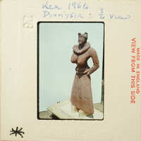 Ancient clay figurine with exaggerated features, possibly representing a deity or mythical creature.