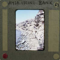 Photo of rocky coastline with AYANI BANK label and handwritten number 63 on the border.