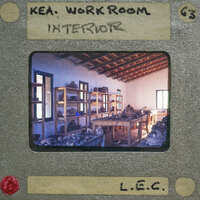 A cluttered workshop interior with shelves filled with various objects, framed within a vintage film strip border.