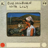 A vintage photo of a woman holding flowers, with the name "Elizabeth" written on it.