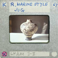 Full jug with tentacle design on table.