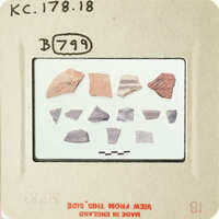 A collection of ancient pottery shards on display.