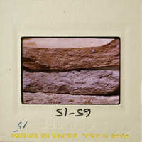 Close-up photograph of a pottery break surface on a film strip.