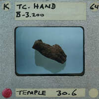 A photograph of a rock with a label identifying it as "Tc-Hand B-32000" from the Temple Temple, dated 30/6.