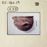 Ancient ceramic pot with worn surface and handle, displayed on white background.