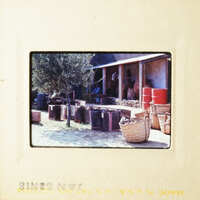 This photo captures an outdoor market scene with various goods and a building in the background.