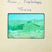 Mounted photograph depicting coastal landscape with rocky cliffs and vegetation, labeled "Miss Phytocopi Tower".