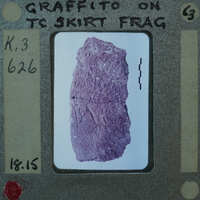 A photograph of a purple rock with cracks on a film strip.