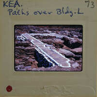 A photograph of a stone bridge with graffiti on the film strip.