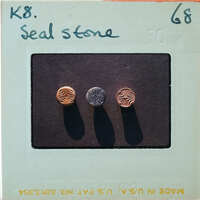 Three buttons with intricate designs on a display card.