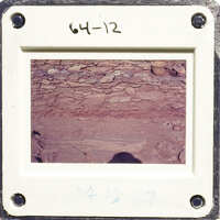 This is an image of a photograph depicting a rock formation with layers and shadows, possibly taken at a site like Mesa Verde National Park.