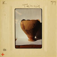 Ancient clay pot with intricate designs on display.