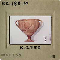 Ancient Greek vase with intricate designs, displayed on a white surface.