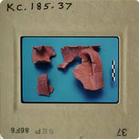 Photograph of ancient pottery fragments with red clay.