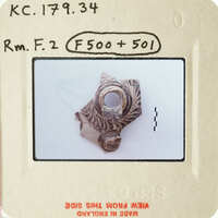 A small, intricately designed ring with an open center.