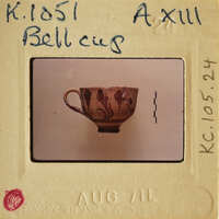 A small, intricately painted ceramic cup on display.