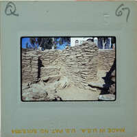 An old, crumbling stone structure with vegetation growing on it.