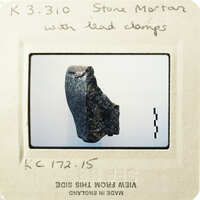 A photograph of an artifact with lead caps, possibly a historical object.