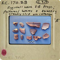 An assortment of ancient pottery shards on display.