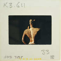 Torso and head of terracotta figurine from the back.