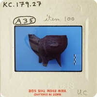 Small clay figurine resembling an animal on a blue background, with a label indicating "Item 100" and other details.