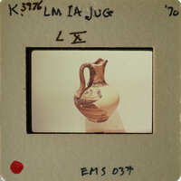 Ancient Greek vase on display with a focus on its handle and neck.