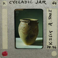 Large reassembled jar (K.2519) with decorations and spout on table.