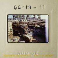 This is an old photograph of a stone wall and ruins, possibly from an archaeological site.