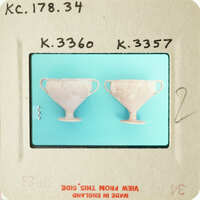 Two ancient Greek style vases on display.