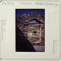 A photograph of an ancient stone archway with sunlight shining through.