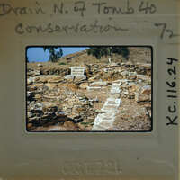 An old photograph of a stone ruins with handwritten notes on the border.