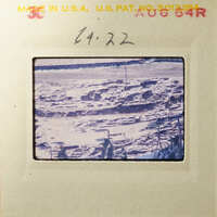 Aerial view of an abandoned mining site with piles of dirt and debris.