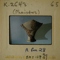 Ancient Greek vase with intricate designs on display.