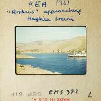 A vintage photo with handwritten notes showing a scenic view of mountains and water, possibly from an album page.
