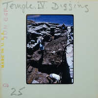 Three workers working on stone walls, partially under muddy water and the sea in the background.