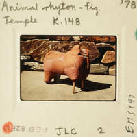 A clay sculpture of an animal on display.