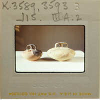 Two reassembled stirrup jars in profile on table, K.3589, K.3593.