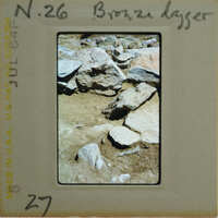 A photograph of a rocky terrain with a label on the front.