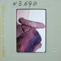 A photograph of stacked rocks with a film strip border.