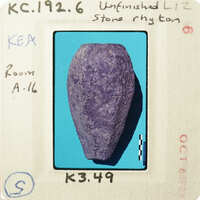 Purple rock on blue background with handwritten labels.