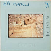 Excavated stone walls in various directions forming rooms.