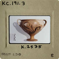 Ancient Greek vase with intricate designs on display.