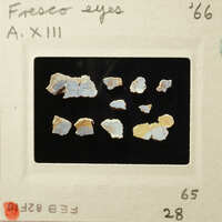 Photograph of small, colorful rock samples on a black background.