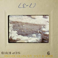 Two vintage photos showing excavation sites with exposed earth and rocks, likely from an archaeological dig.