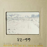 This is an image of a film strip with a view of an arid landscape and a building.