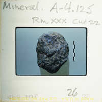 A photograph of a rock on film with annotations and numbers written on it.