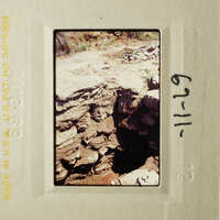 This is an image of a rock formation with a handwritten note on the bottom right corner.