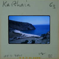 A vintage photo of a coastal landscape with a sandy beach and blue water, labeled "Katharina" on the bottom left corner.